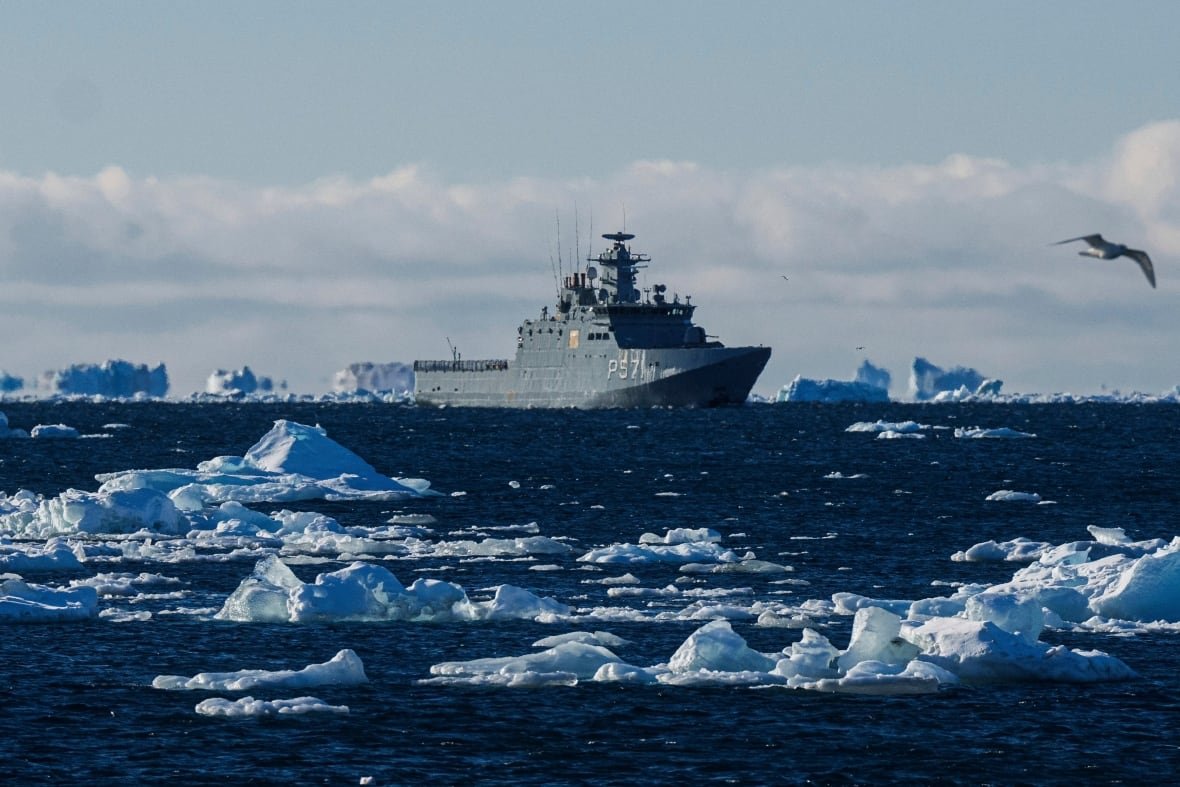 A military vessel patrols northern waters filled with icebergs.