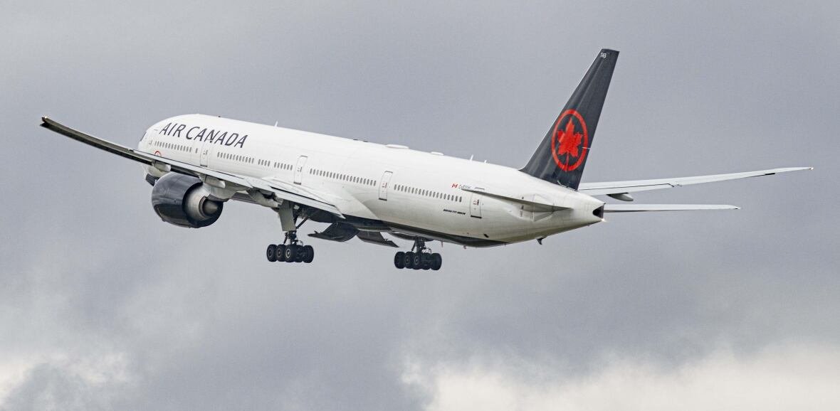 An airplane is seen on a cloudy day.