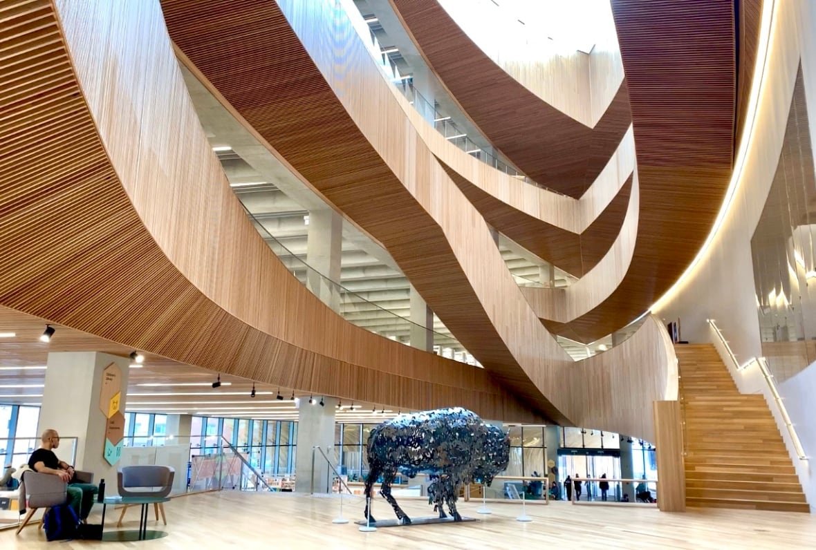 A large wooden staircase inside a library.