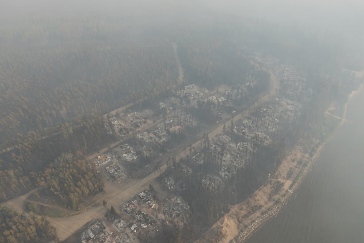 An areal shot of a community burned by wildfire.