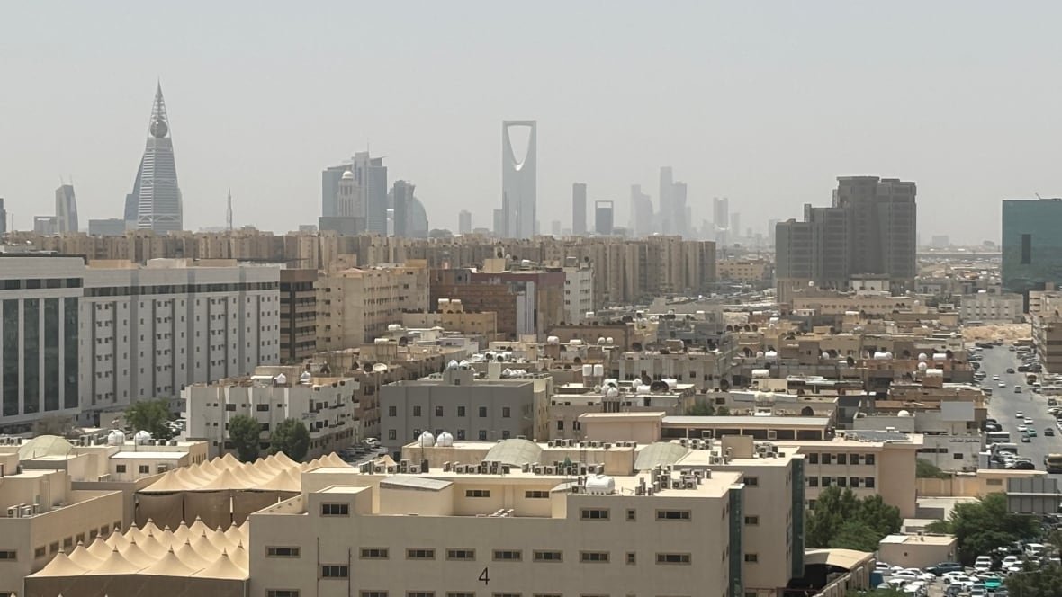 The skyline of Riyadh's financial district,  with the Kingdom Tower in the centre.