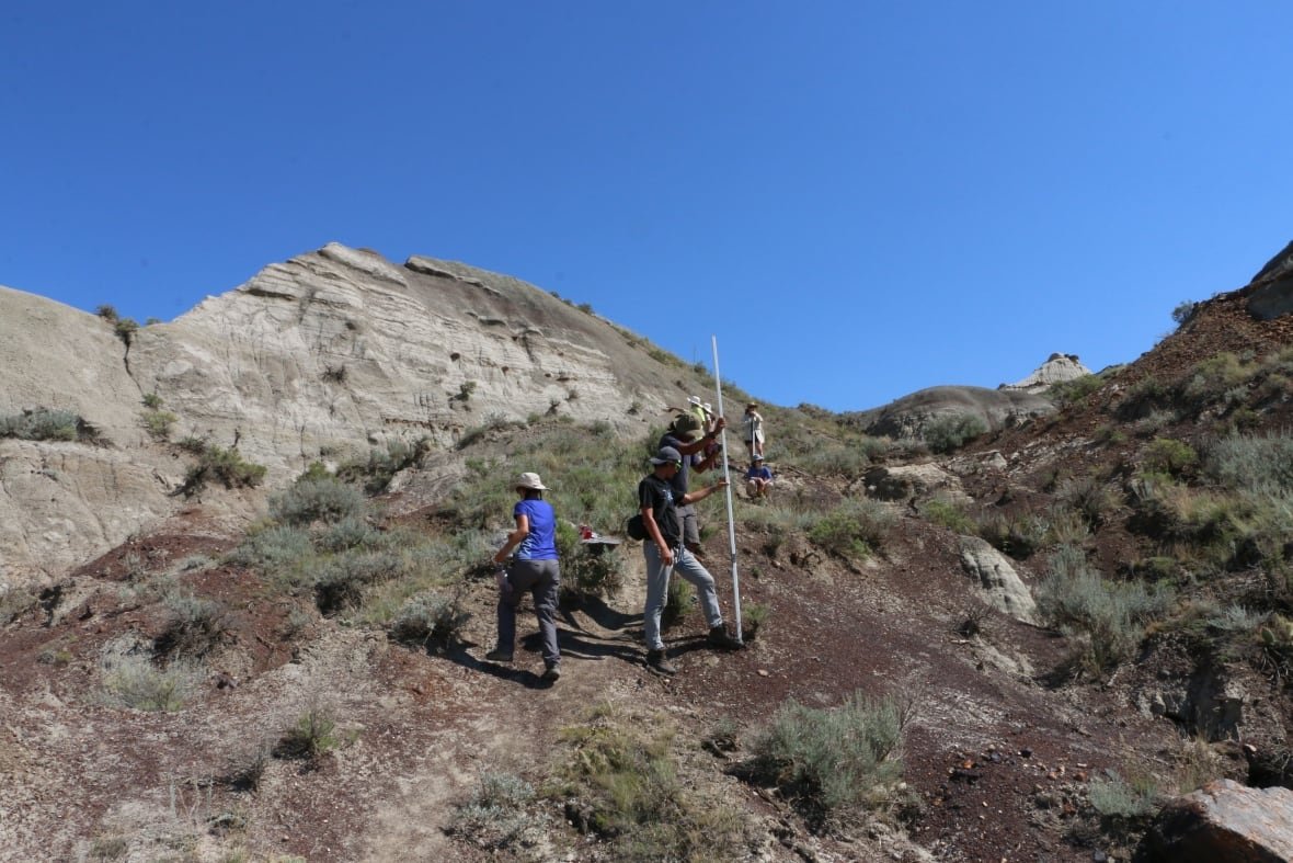 People standing in Alberta's badlands.