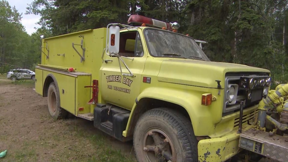 A yellow fire truck that says Timber Bay Fire Truck.