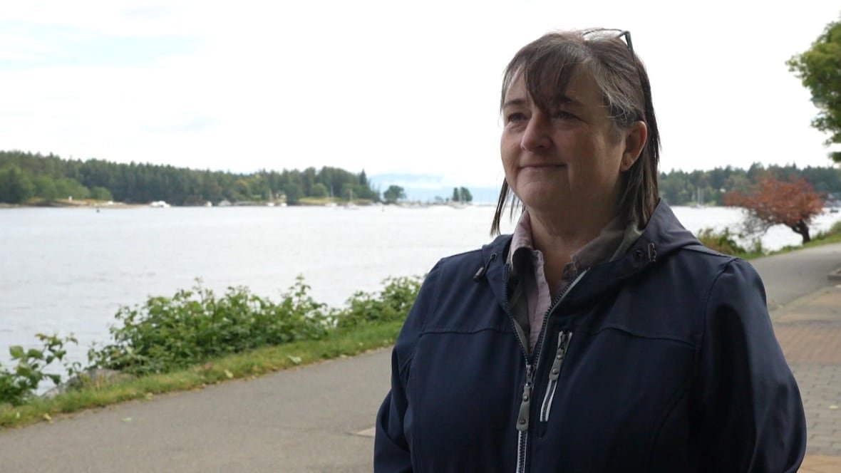 A woman stands outside.