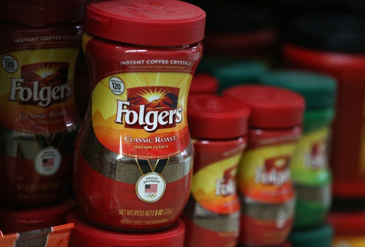 Packages of Folgers coffee are displayed on a shelf at a grocery store