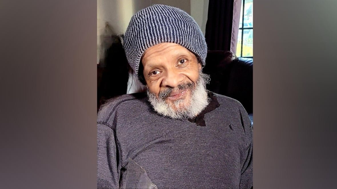 A man is shown smiling in a photo.