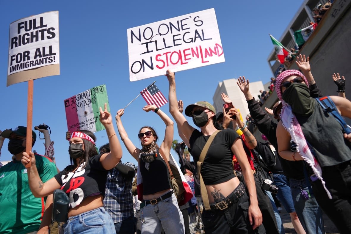 Protesters hold up signs during a demonstrations.