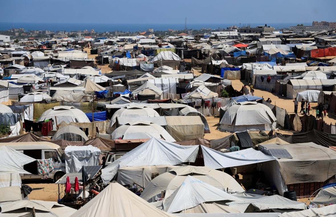 An immense spread of tents and makeshift shelters stretches into the distance. 