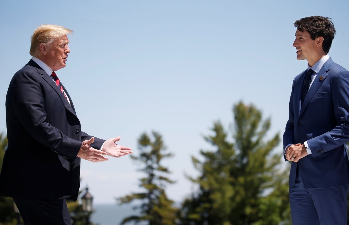 U.S. President Donald Trump approaches Canada's Prime Minister Justin Trudeau as he arrives at the G7 Summit in Charlevoix, Quebec in June 2018. 