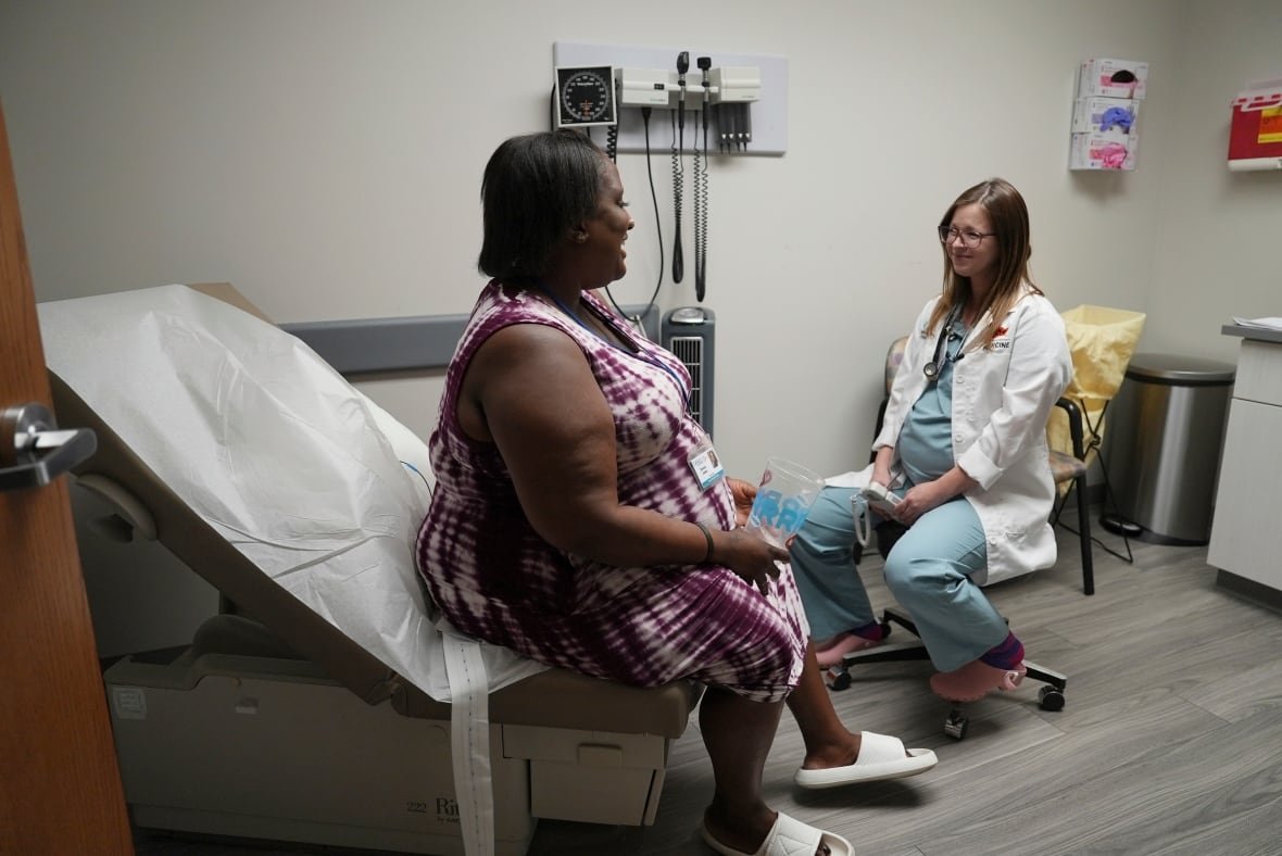 Denise Jones speaks with Dr. Allison Garnett during a prenatal appointment