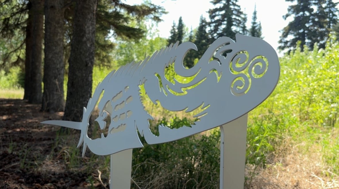 A photo of a white grave marker. 