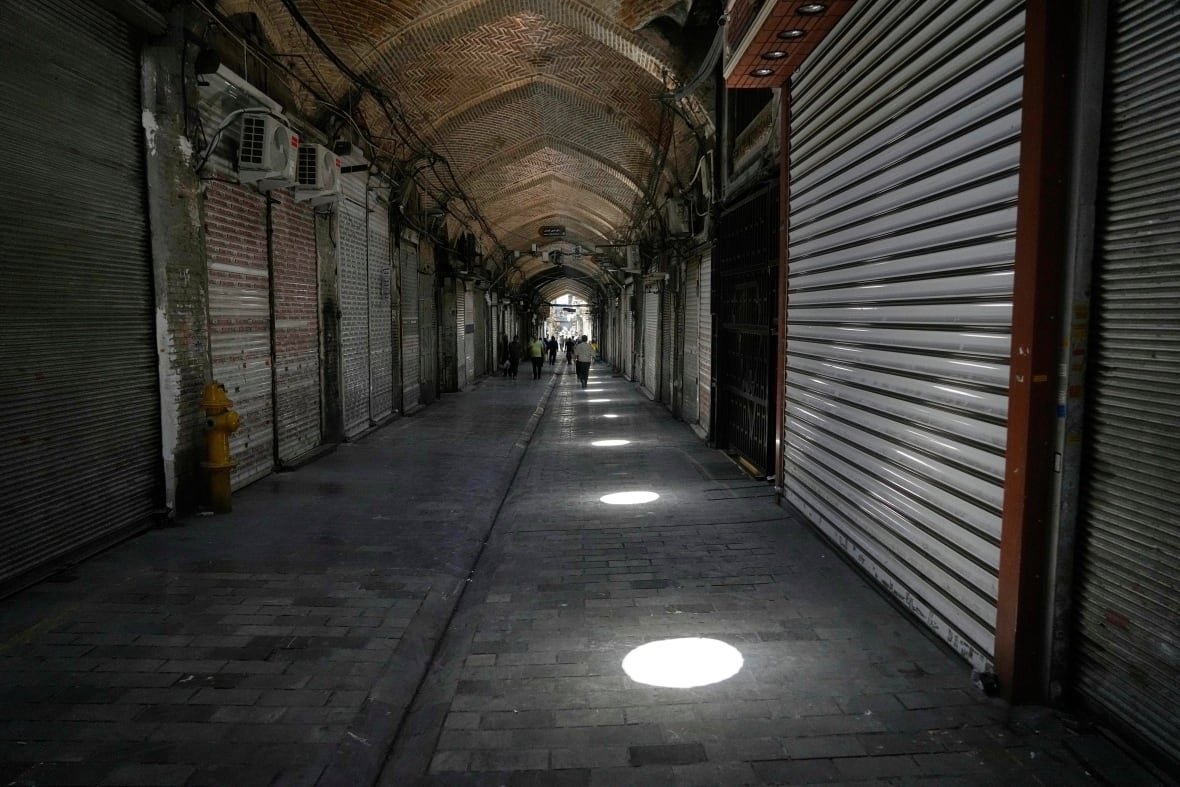 A hallway of closed garage-like doors 