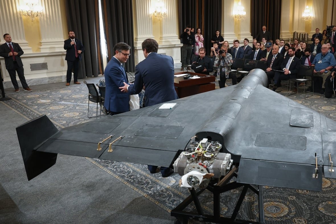  U.S. Speaker of the House Mike Johnson (L) (R-LA) shakes hands with Mark Wallace, CEO of the non-profit United Against Nuclear Iran, after Johnson delivered remarks next to a Shahed 136 military drone during a press conference on Capitol Hill May 8, 2025 in Washington, DC. The press conference, organized by United Against Nuclear Iran, occurred as the United States and Iran continue to negotiate over bilateral issues and growing international concern with Iran’s drone production and proliferation.