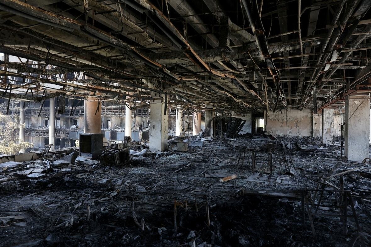 The floor of a building is shown charred by fire.