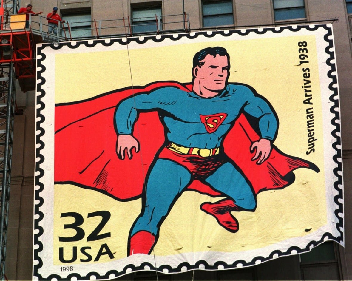 In this Sept. 10, 1998, file photo, workers raise a five-storey replica of a U.S. postage stamp of Superman on Terminal Tower in Cleveland.