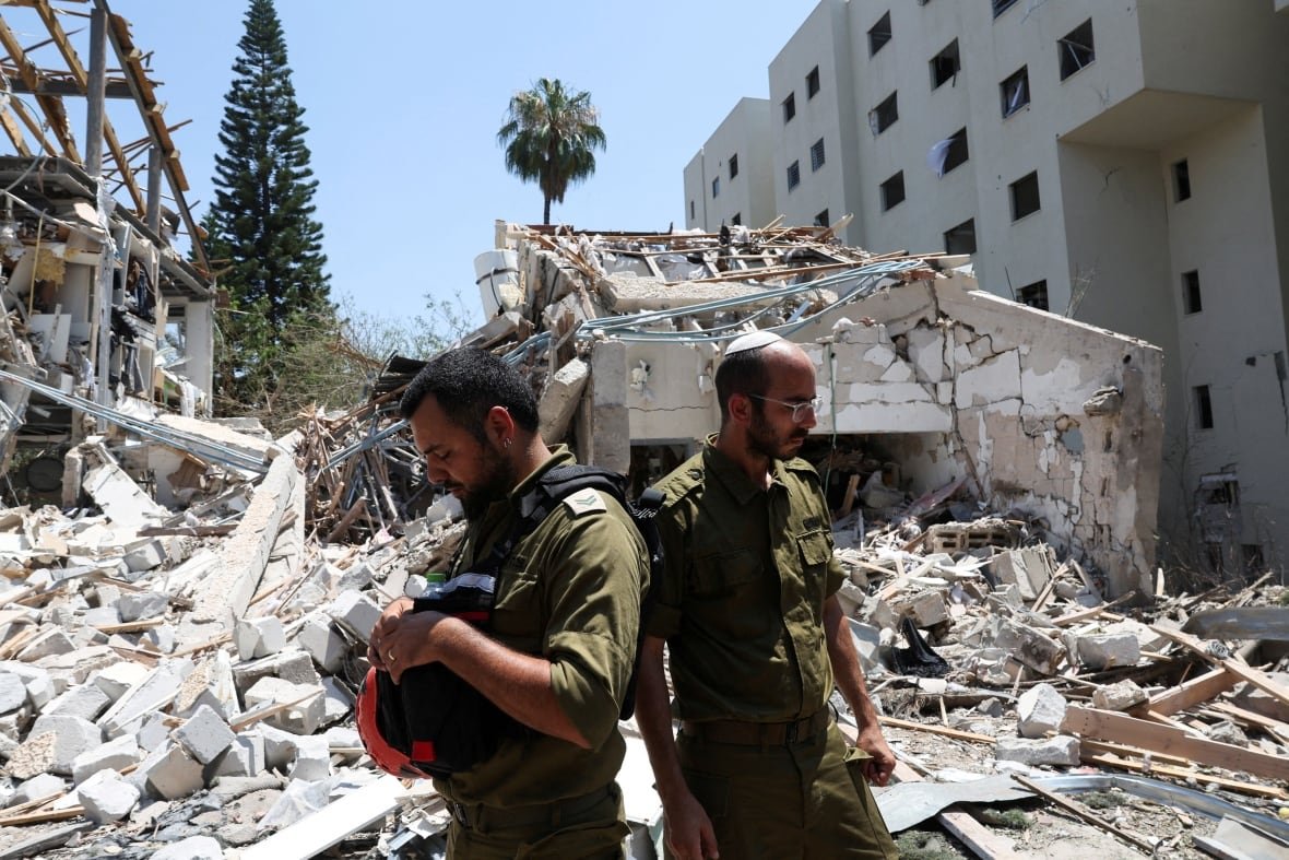 Members of Israeli forces work at an impact site following a missile attack from Iran on Israel, amid the Iran-Israel conflict, in Tel Aviv, Israel, June 22, 2025.
