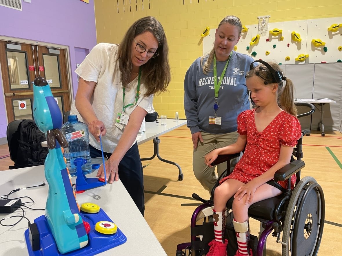 Irelynn, age 10, is wearing a headset that allows her to control some objects through a brain computer interface. She has limited mobility, but with the technology can make toys make music.