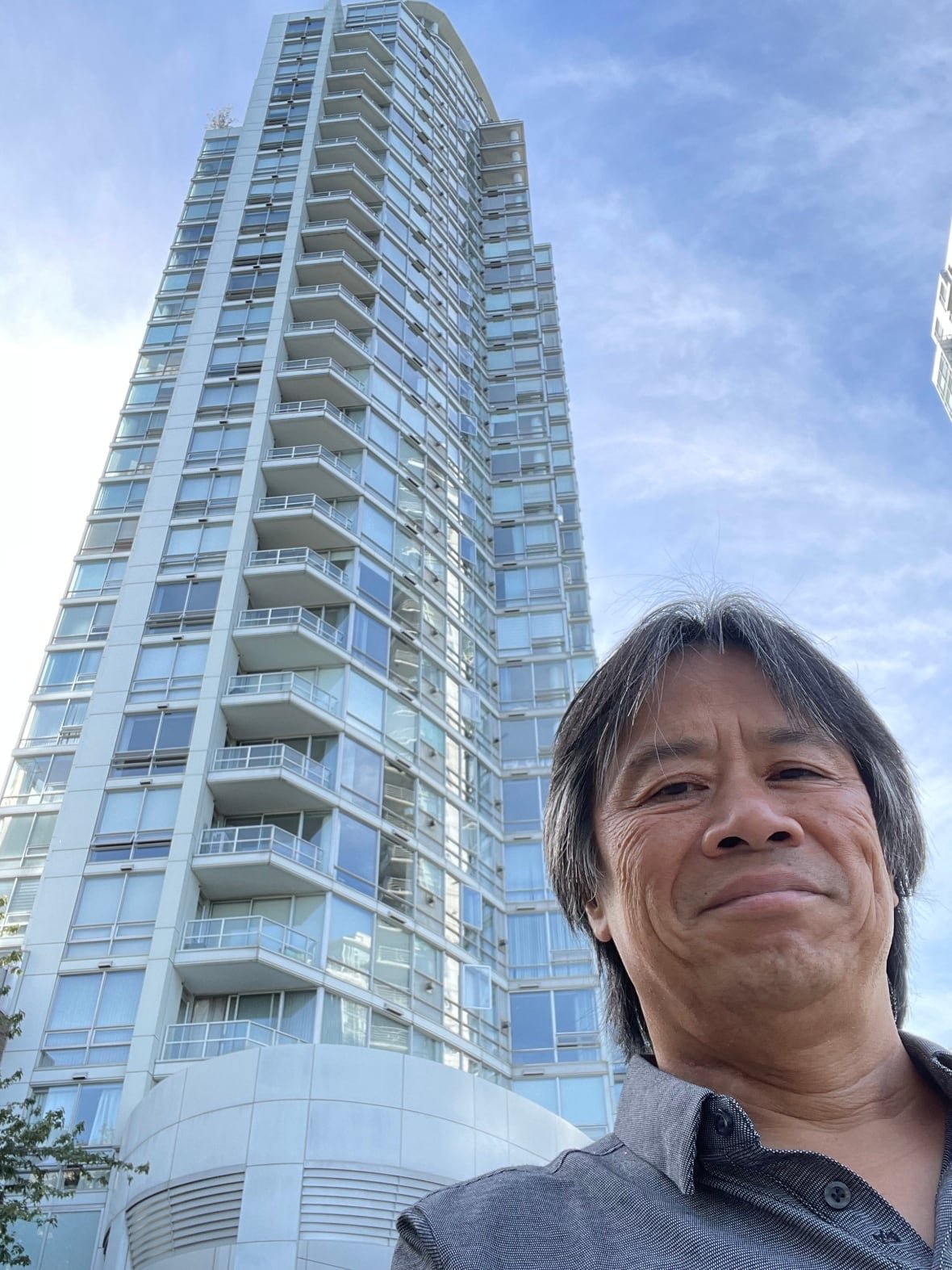 Man with highrise behind him