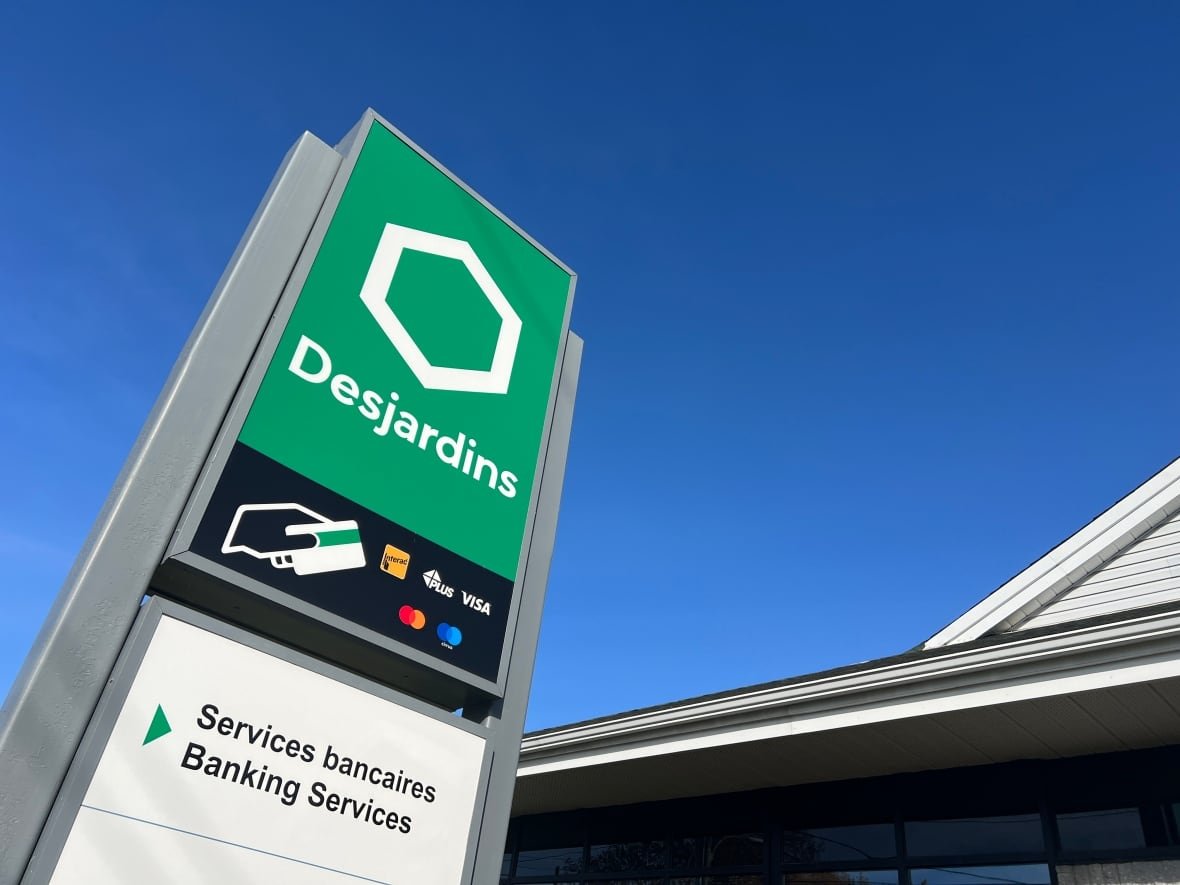A Desjardins Group signboard against a blue sky.