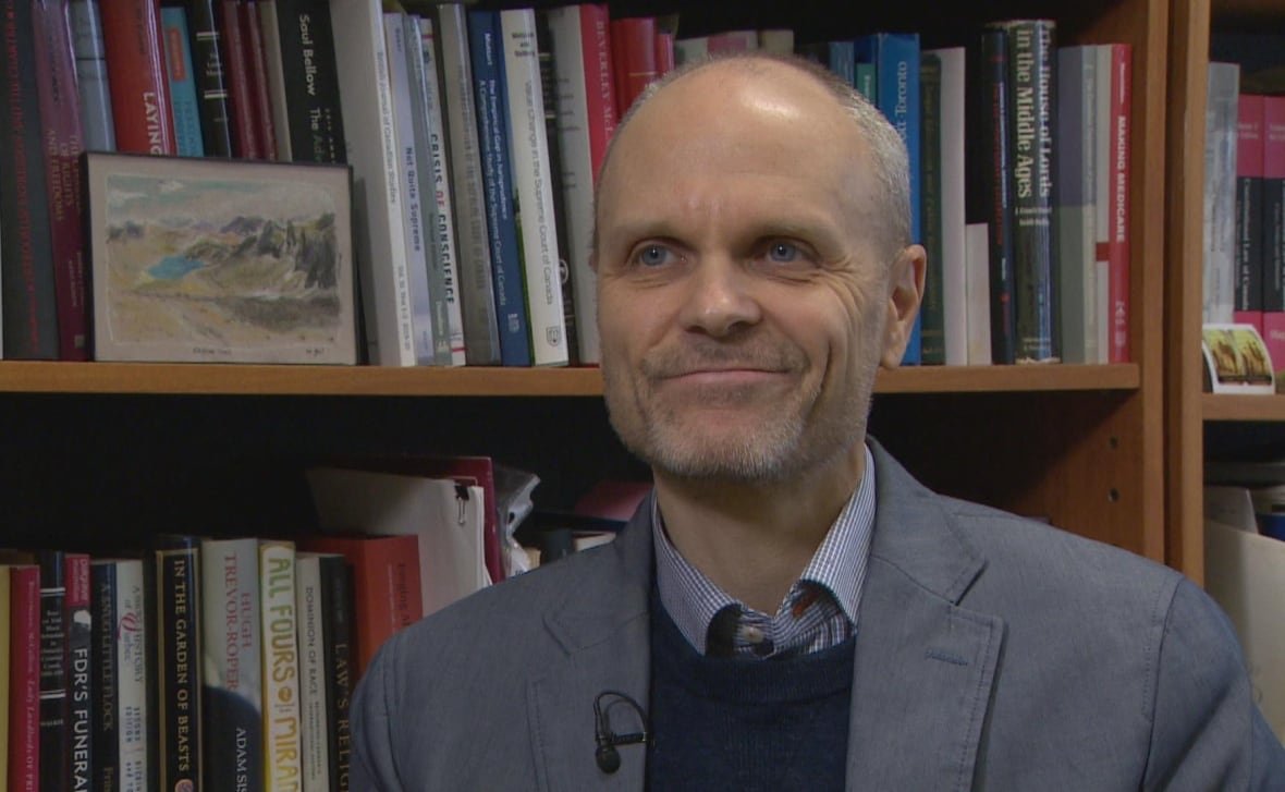 A man wearing a suit is pictured.