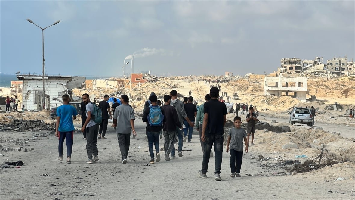 Palestinians in Khan Younis trek to one of only a handful of food distribution sites,  amid vast devastation from Israeli attacks.
