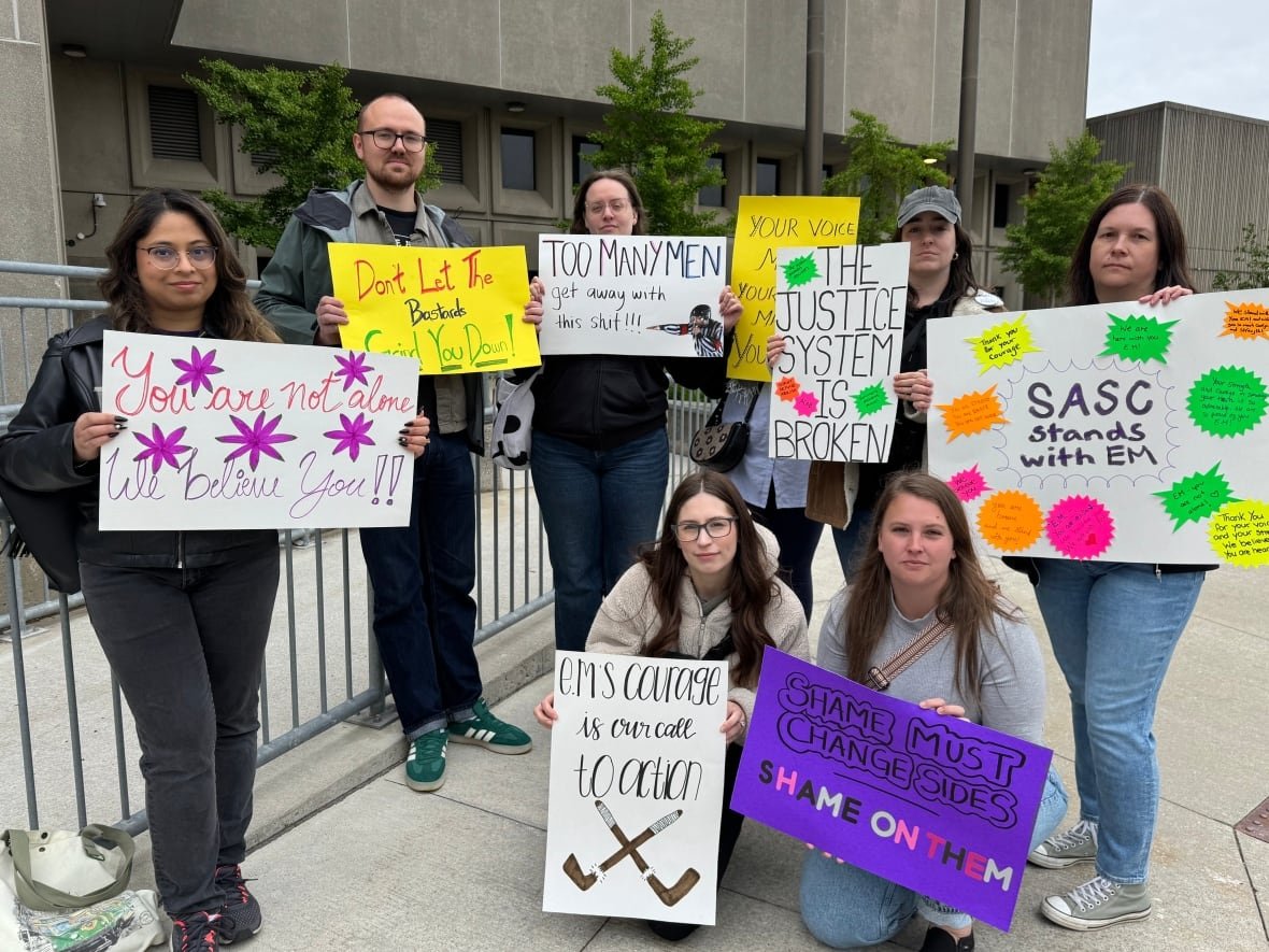 Landon Kenney (second from left) at the courthouse in London, Ont., on May 28. Kenney is a male allyship educator at the Sexual Assault Centre of Waterloo.