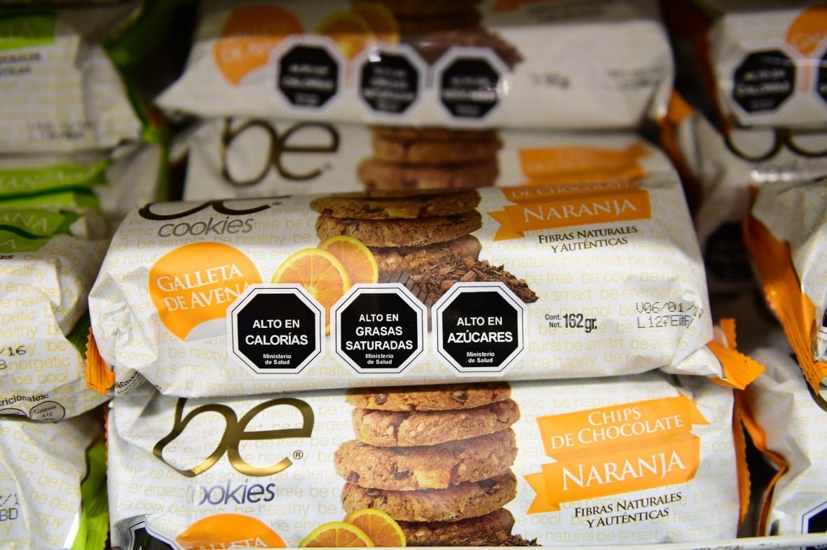 package of cookies with stop-sign shaped warning labels abotu calories, saturated fat and sugar.