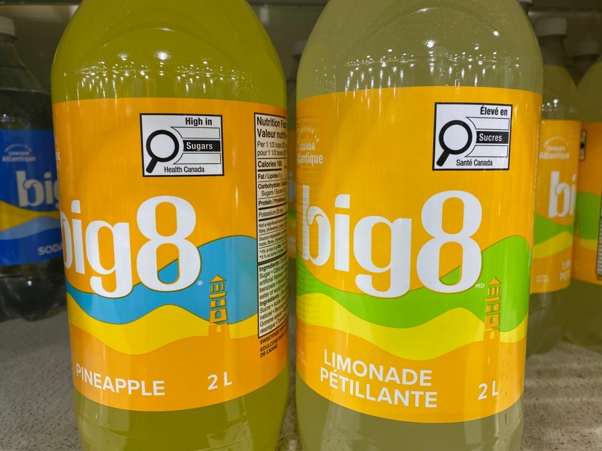 Two plastic bottles filled with yellow liquid