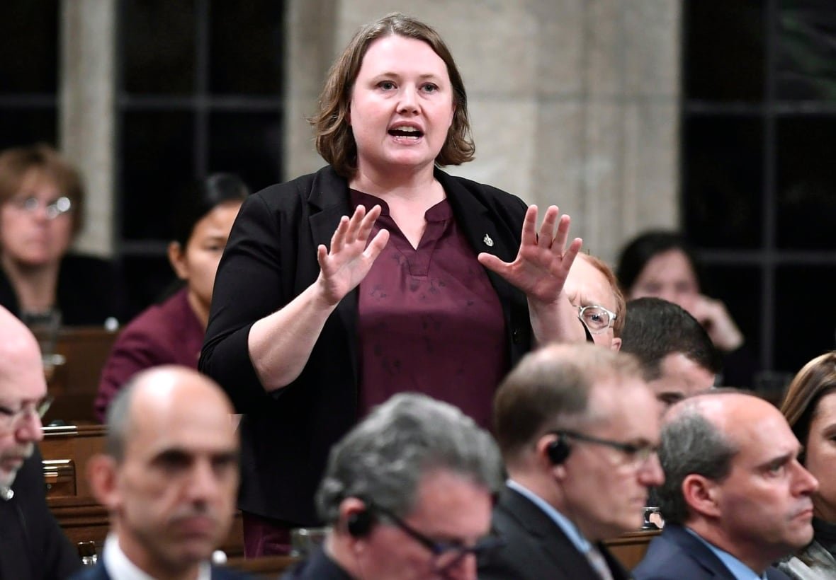 A woman stands and speaks in the House of Commons.
