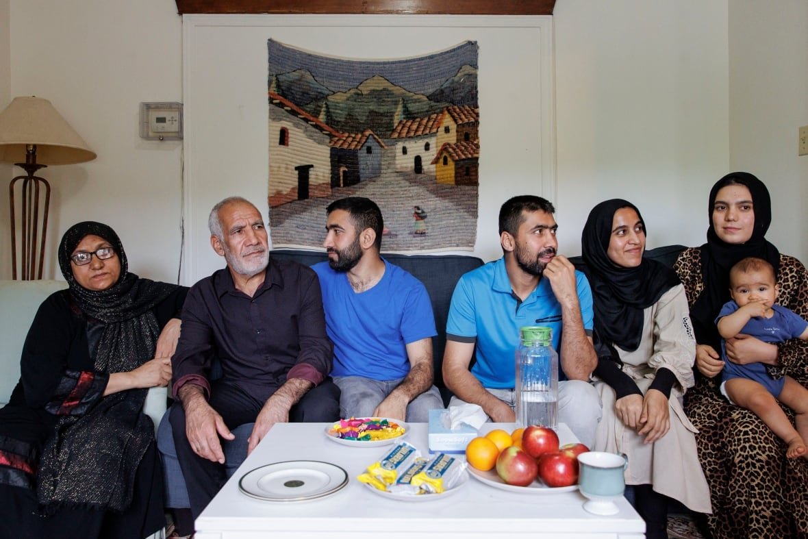 The family of Mohammad Younesi, who fled Taliban persecution in Afghanistan, are pictured at a home provided by Romero House which helps settle new refugees in Toronto. 