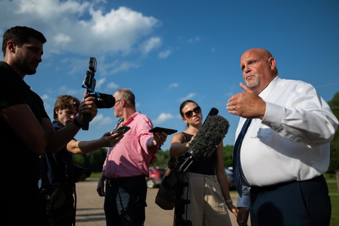 Bill Dickson speaks to reporters outside the town hall.