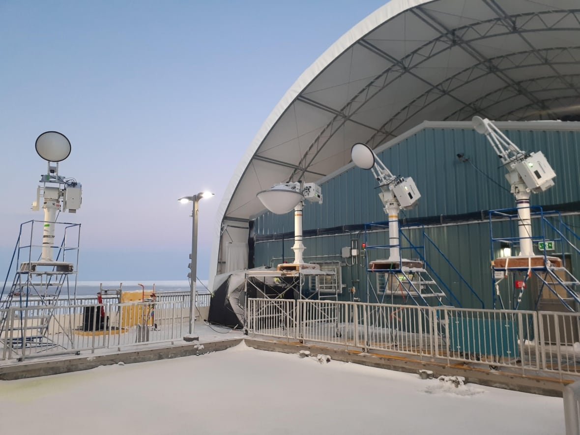 Data collecting machines that look like spotlights surround a pool of frozen water