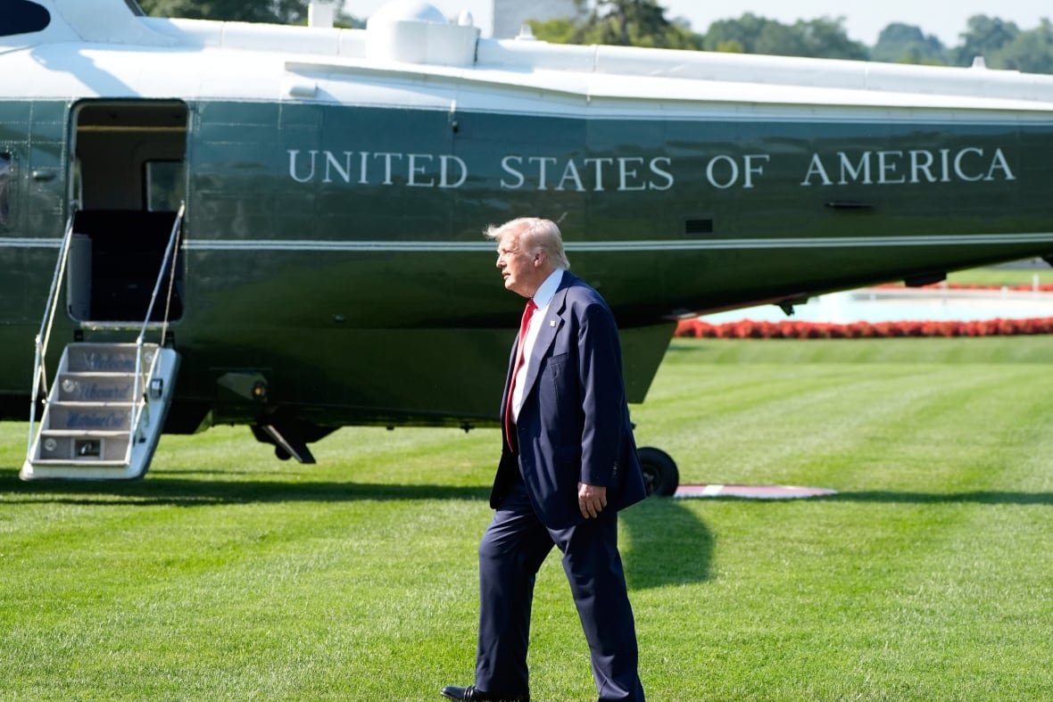 Trump in front of a helicopter