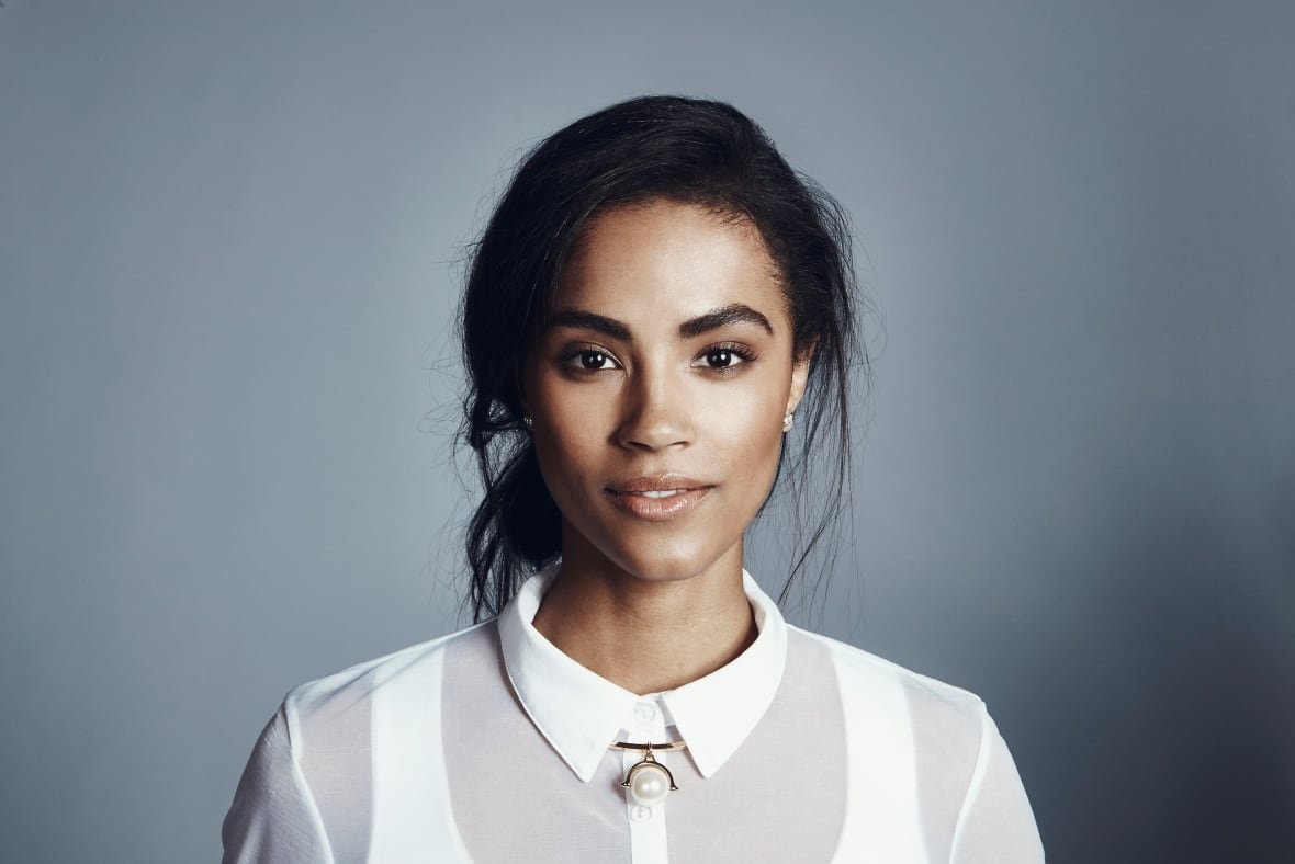 A professional headshot photo of a woman in a white shirt facing the camera.
