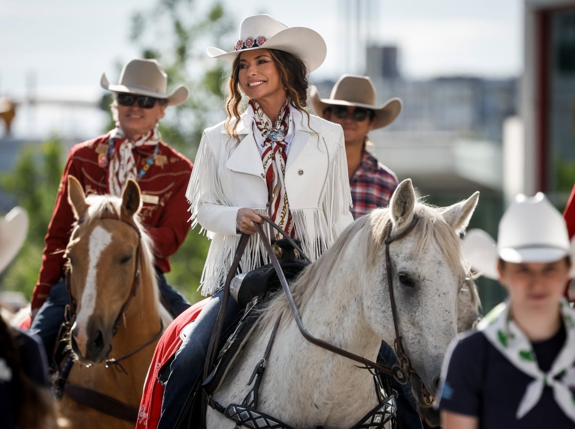 Parade Marshal Shania Twain, centre, rides a horse during the Calgary Stampede parade in Calgary.