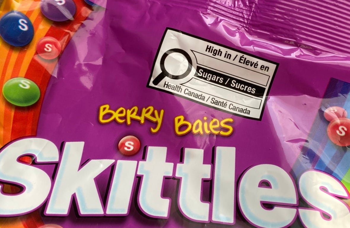 A black and white box on a package of candy warning that it's high in sugar.