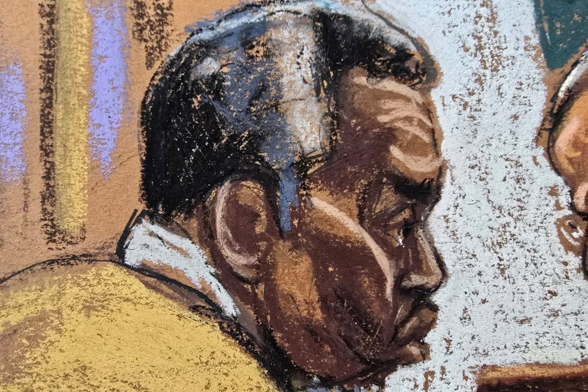 A court sketch shows a man leaning in to speak with his lawyer.