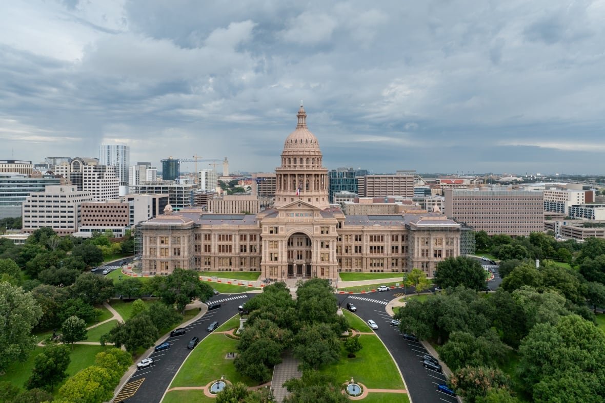 An aerial shows a large government building.