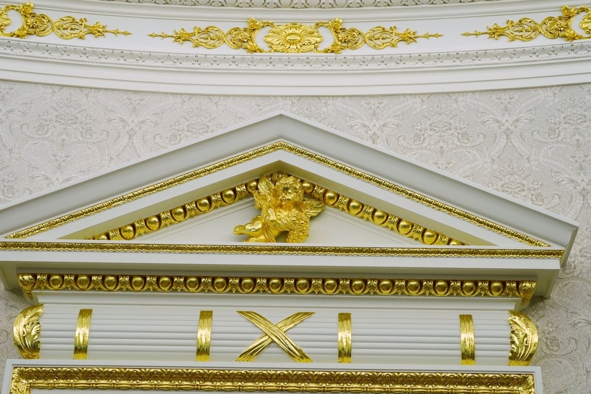 A detail of gold leaf above a doorway to the Oval Office and on the crown work is seen at the White House, Tuesday, April 22, 2025, in Washington.