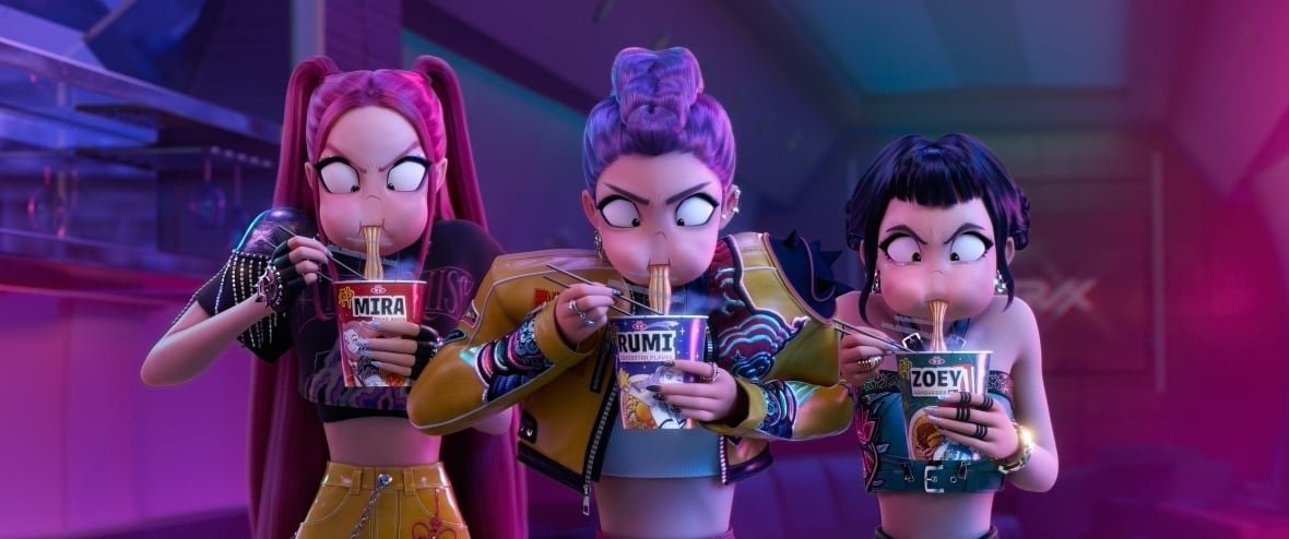 Members of the fictional K-pop group Huntr/x, from left to right, Mira, Rumi and Zoey, are seen eating ramyeon noodles in a still image handout from the film 'KPop Demon Hunters.'