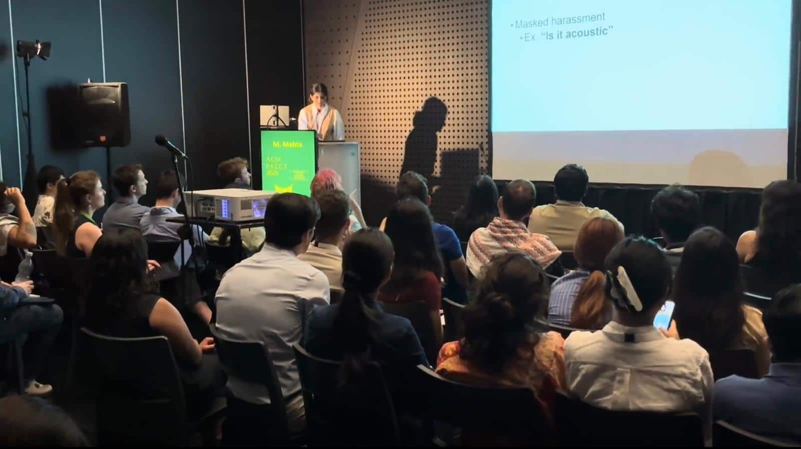 A girl presents on stage at a conference. 