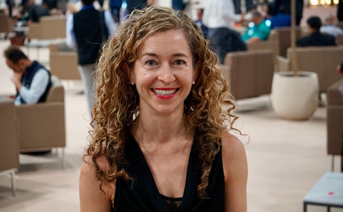 A woman smiles at the camera.