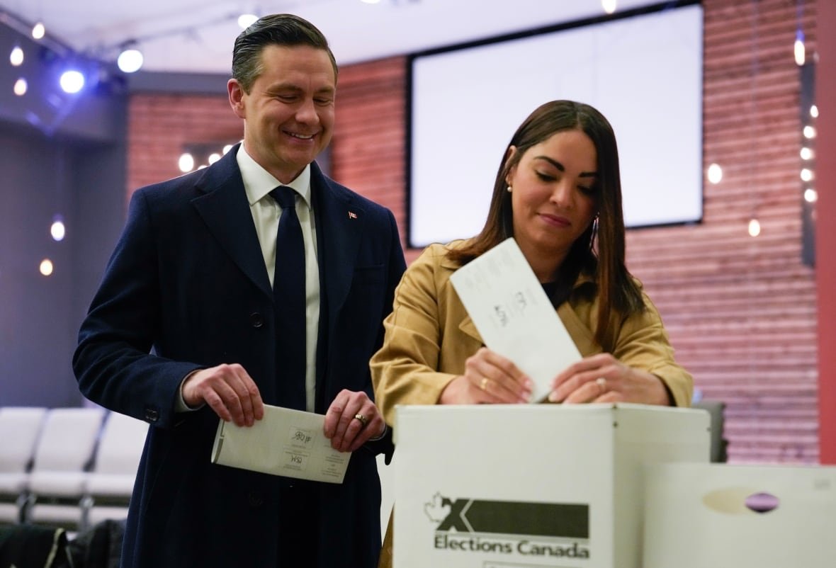 Conservative Leader Pierre Poilievre looks on as his swife Anaida Poilievre casts her vote in the federal election Monday April 28, 2025 in Ottawa.