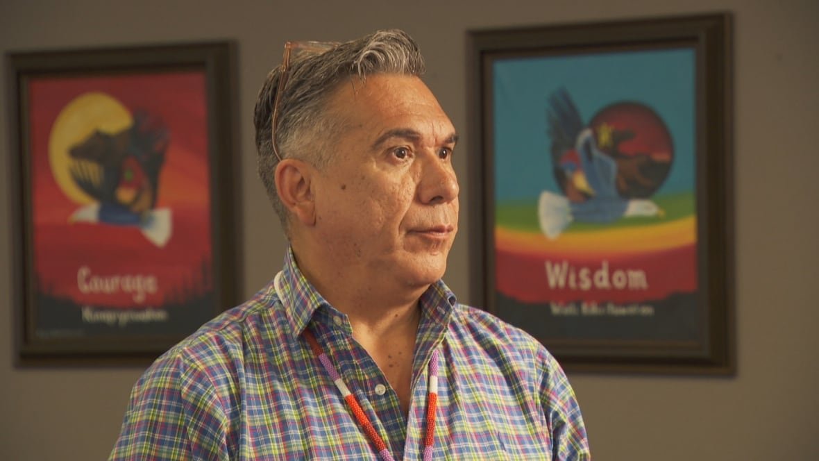 Allan Polchies stands inside a board room at Sitansisk First Nation's office.