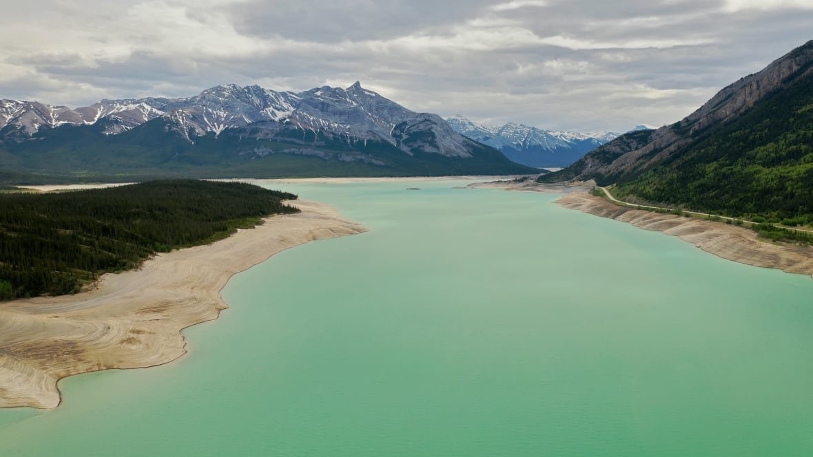 A lake with mountains behind.