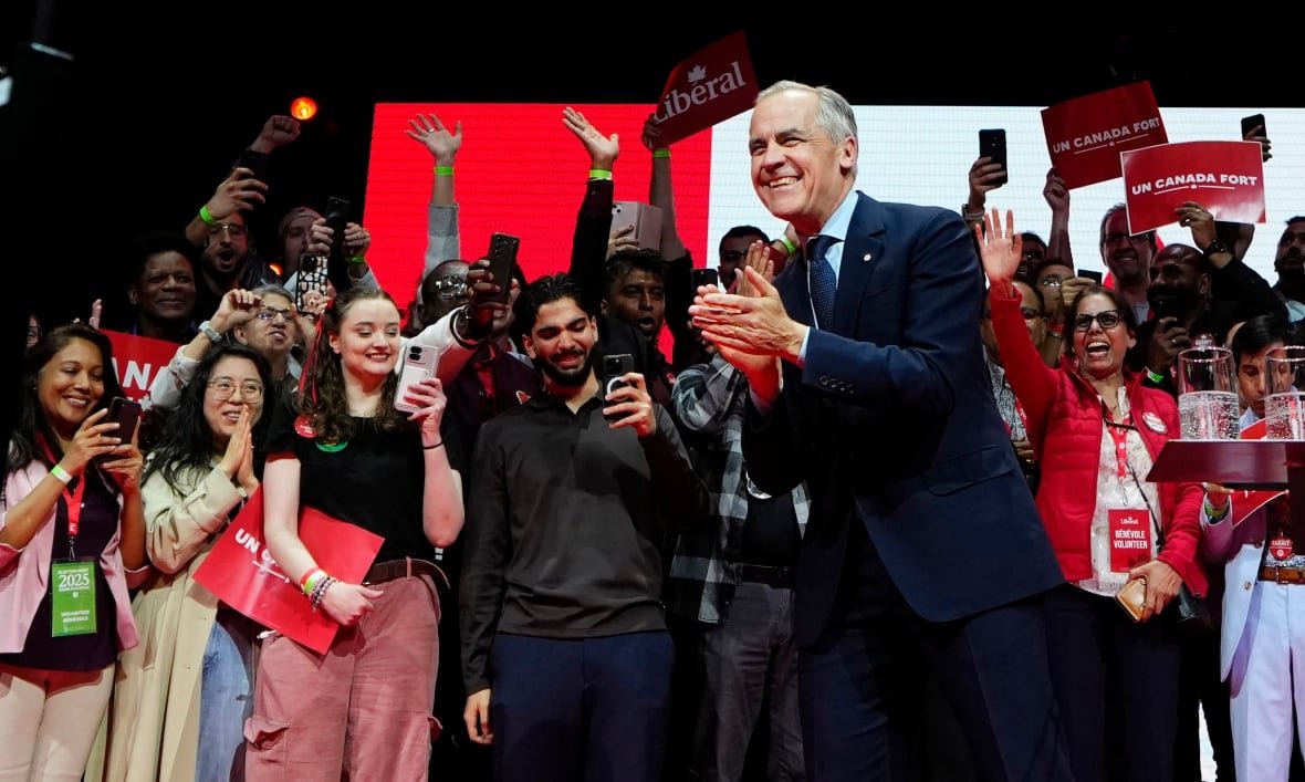 A person on stage clapping his hands. 