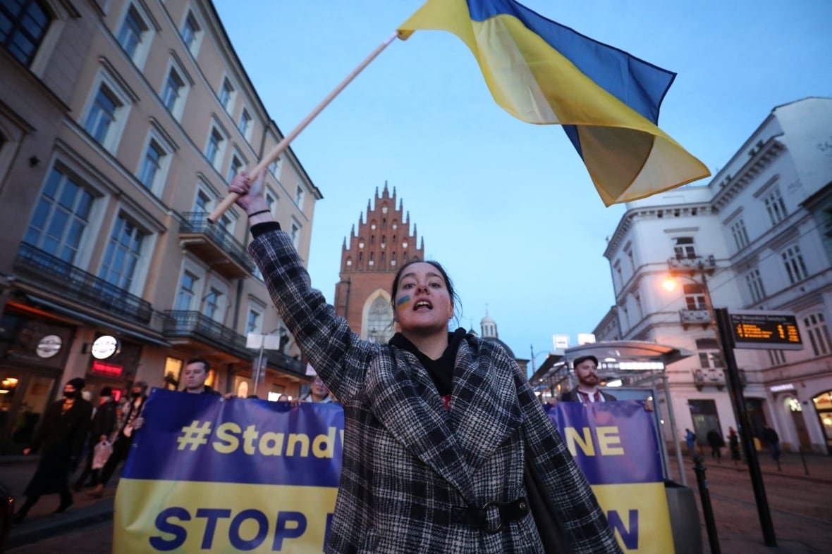 A woman carries a flag during a protest.