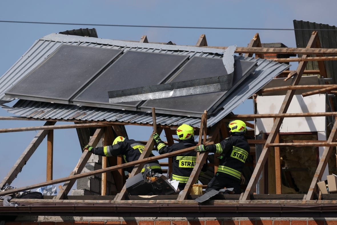 Firefighters work on the destroyed roof of a house, after Russian drones violated Polish airspace during an attack on Ukraine, with some being shot down by Poland with the backing from its NATO allies, in Wyryki, Lublin Voivodeship, Poland, September 10, 2025