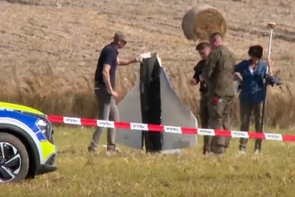 In this image made from video, Police and Military Police secure parts of a damaged object shot down by Polish authorities  at a site in Wohyn, Poland, Wednesday, Sept. 10, 2025.