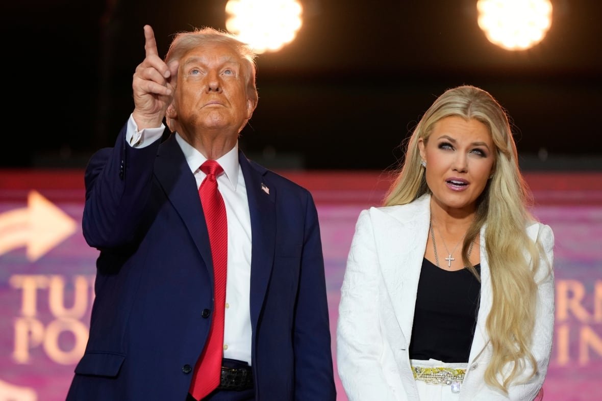 President Donald Trump, left, stands with Erika Kirk at the conclusion of a memorial for her husband, conservative activist Charlie Kirk, Sunday, Sept. 21, 2025, at State Farm Stadium in Glendale, Ariz. 